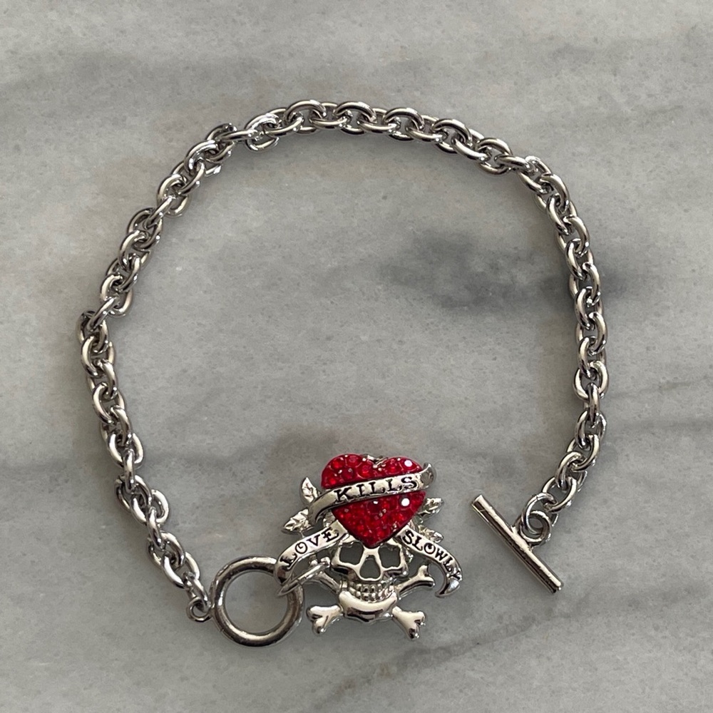 Silver tone chain bracelet with read heart charm.